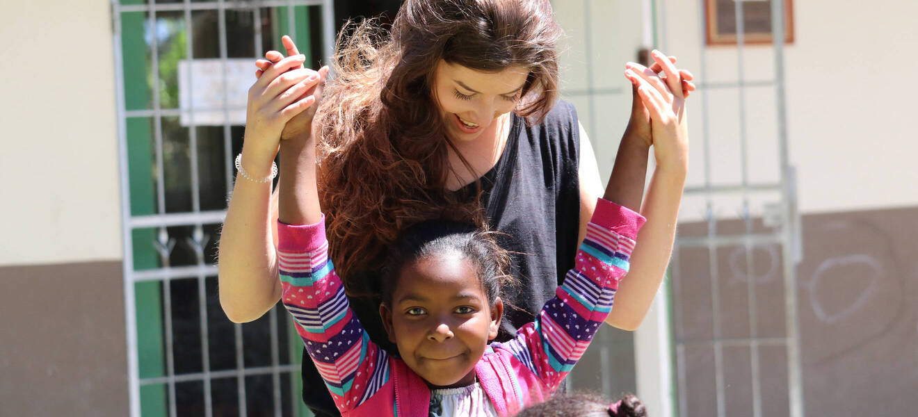 Volunteer with a child in South Africa