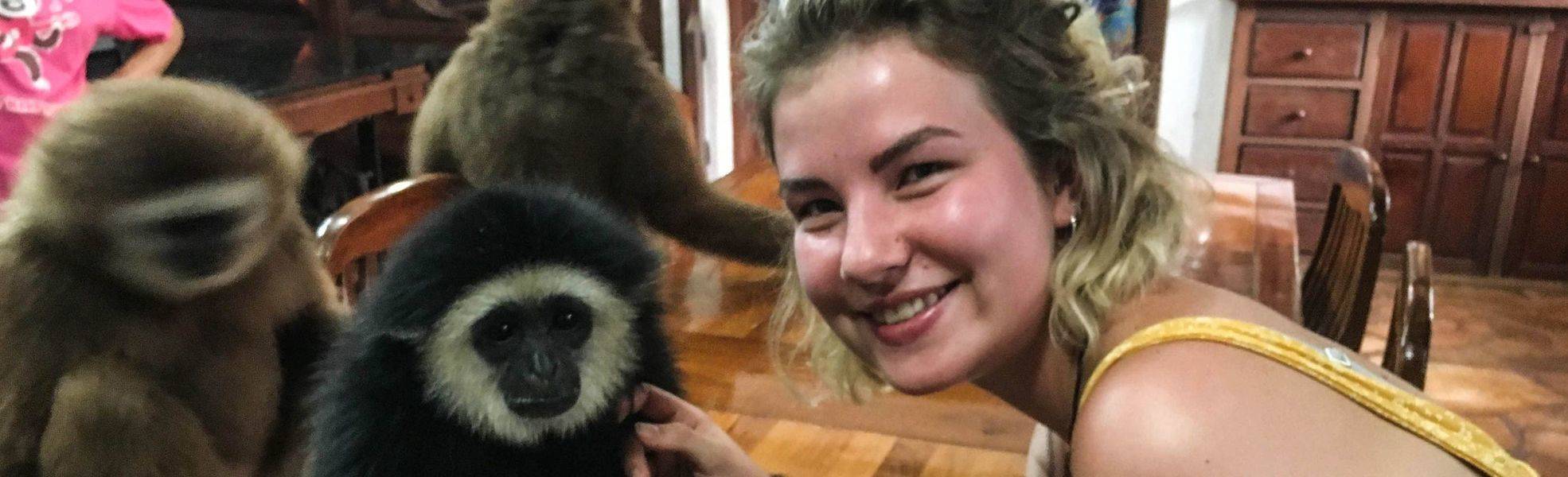 Volunteer on her internship abroad in Asia with monkeys