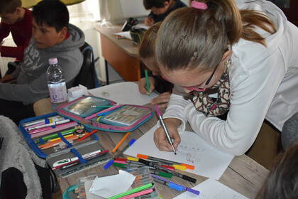 Child painting in the After School Club in Transylvania