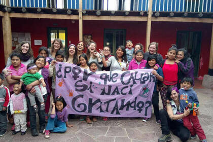 Volunteers, women and children in the women's shelter in Cusco