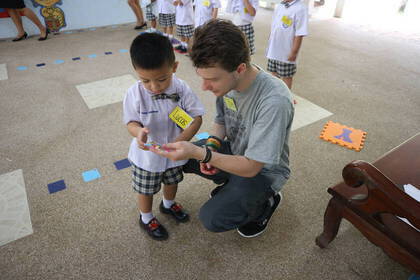 Volunteers teach children English in a playful way