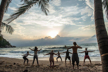 Joint yoga exercises on the beach