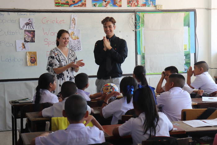 Volunteers teach English at a school in Thailand